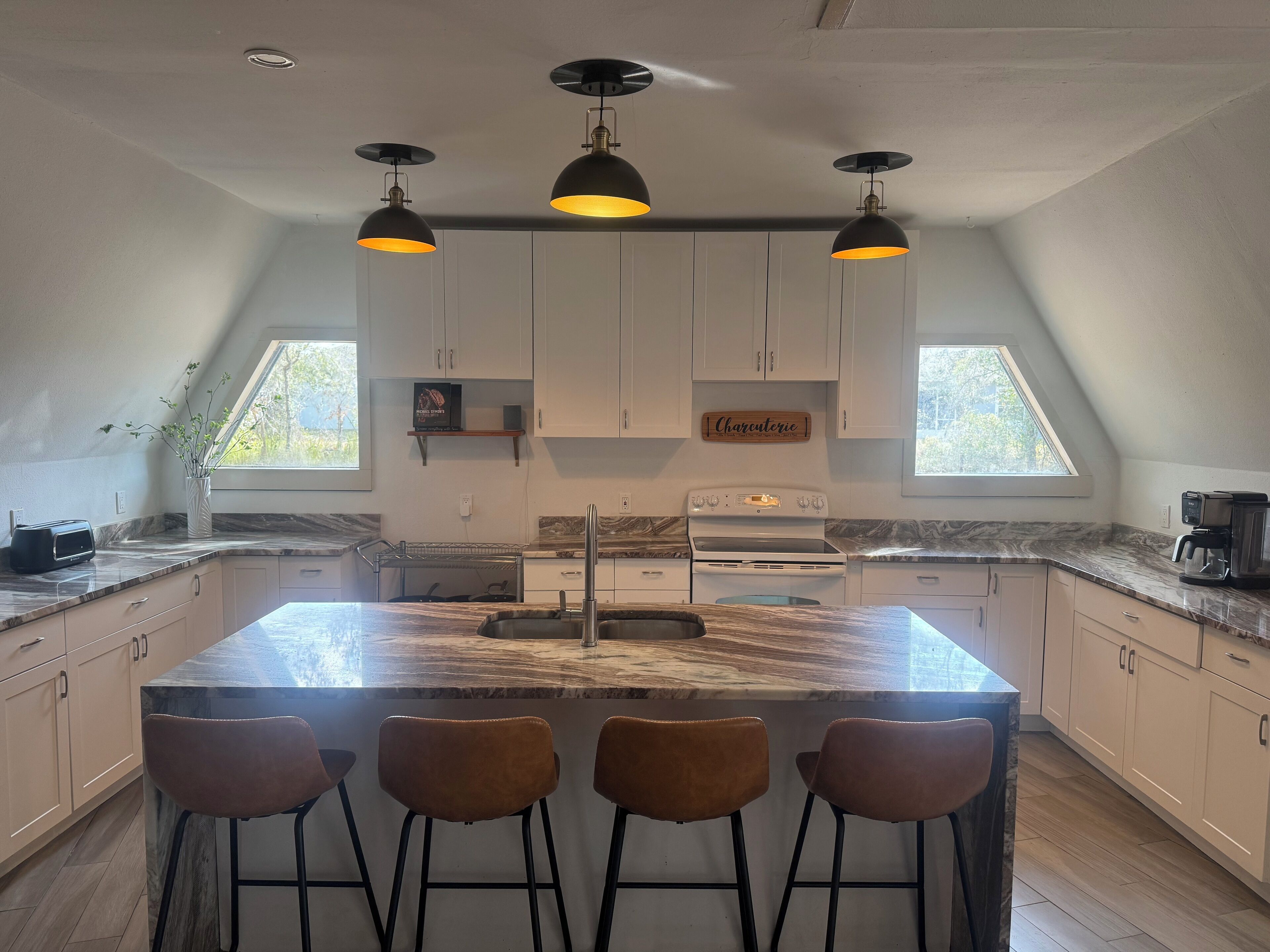 Open kitchen with island and skylights